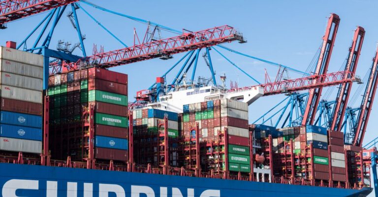 Shipping containers and cranes at Hamburg port showcasing global trade.