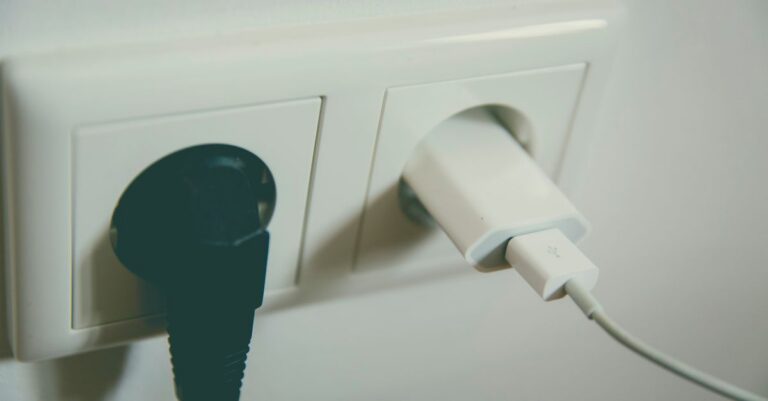 A close-up view of a wall outlet with two plugs inserted, capturing the simplicity of electrical connectivity.