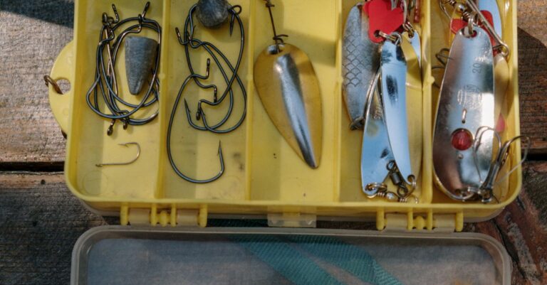 Yellow tackle box containing various fishing hooks and lures for angling enthusiasts.