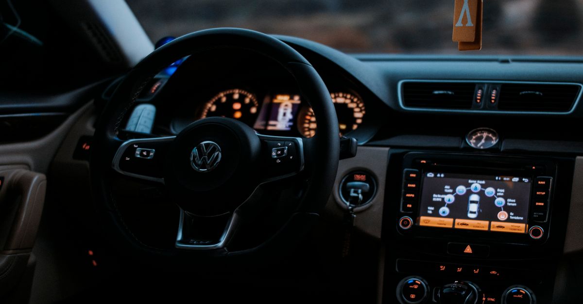 Cozy Volkswagen car interior showing dashboard display and steering wheel.
