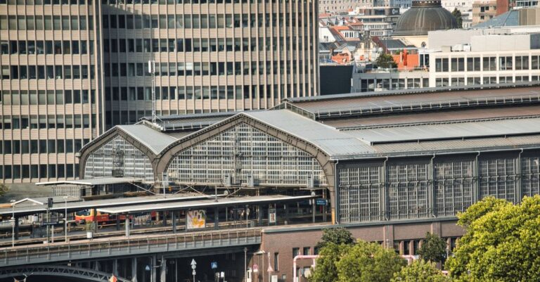 A scenic view of a Berlin railway station amidst urban architecture.