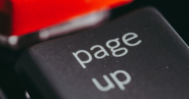 Close-up macro photography of a keyboard's 'page up' key, highlighting its texture and design.
