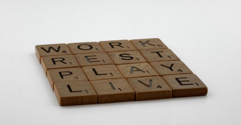 Scrabble tiles spelling work, rest, play, live emphasize life balance and priorities.